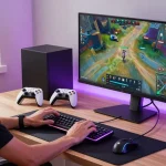 Dynamic gamer testing wireless keyboard and headset in stylish home office from https://rokok88.jp.net
